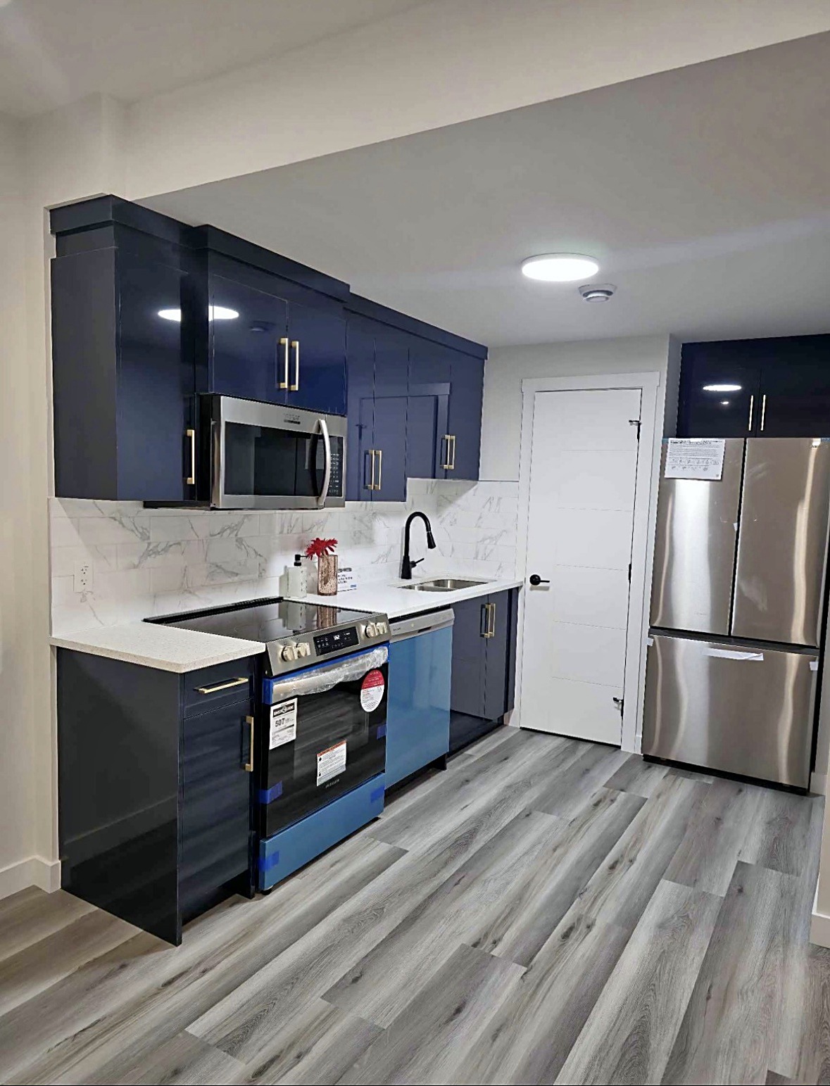 Finished kitchen with navy cabinets and clean wall paint